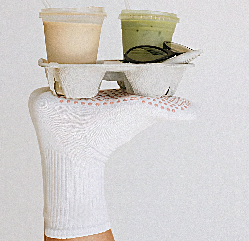 Grip socks holding a drink tray